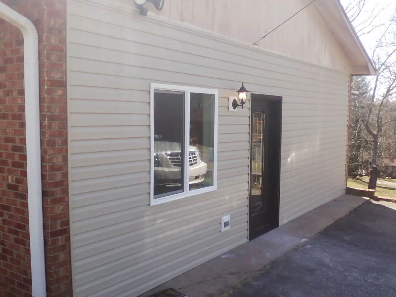 New vinyl siding and entry door on a room addition in Francisco