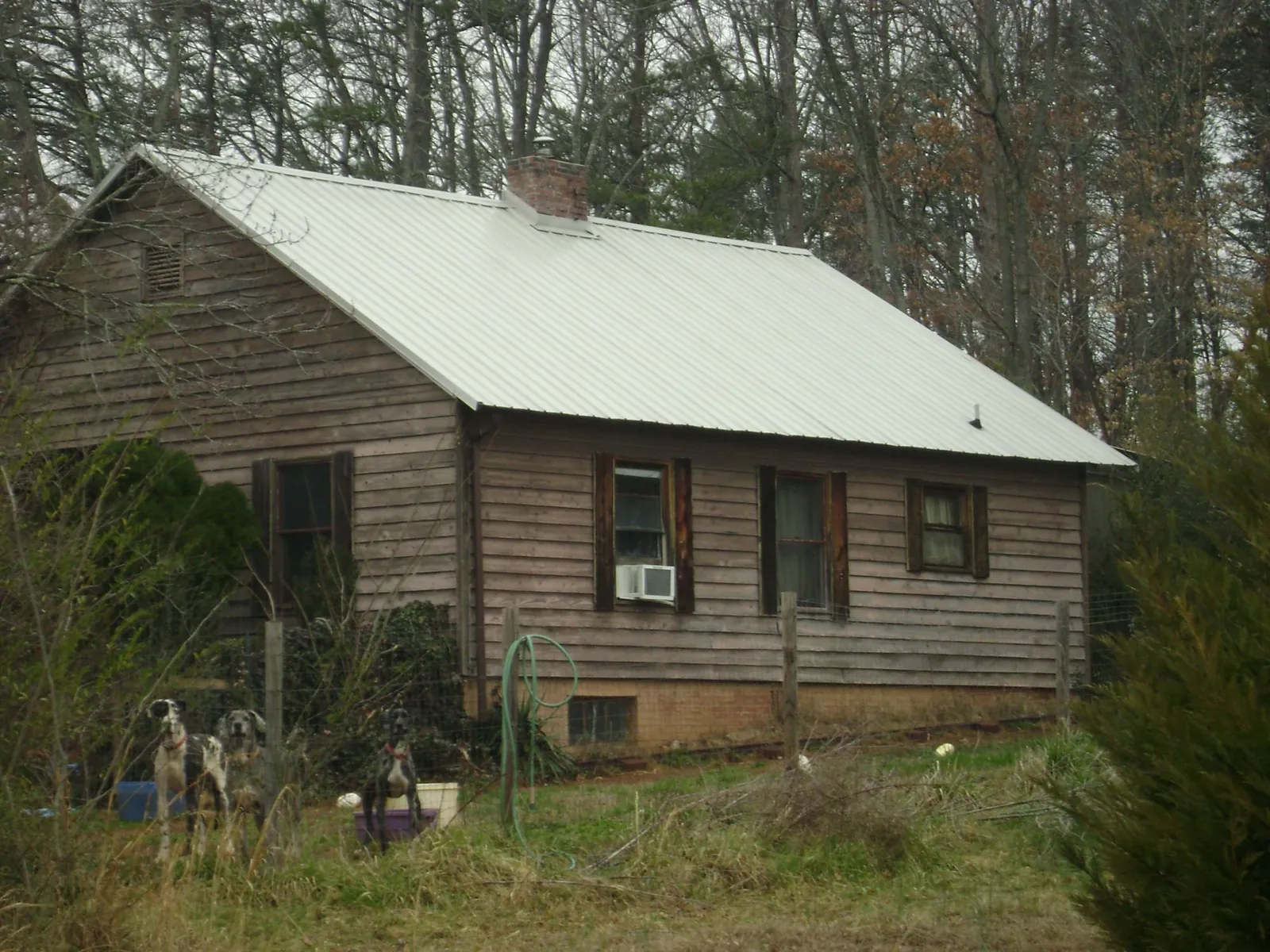 White metal roof on an old wood sided farmhouse, from a Metal Roof Installation job in Francisco